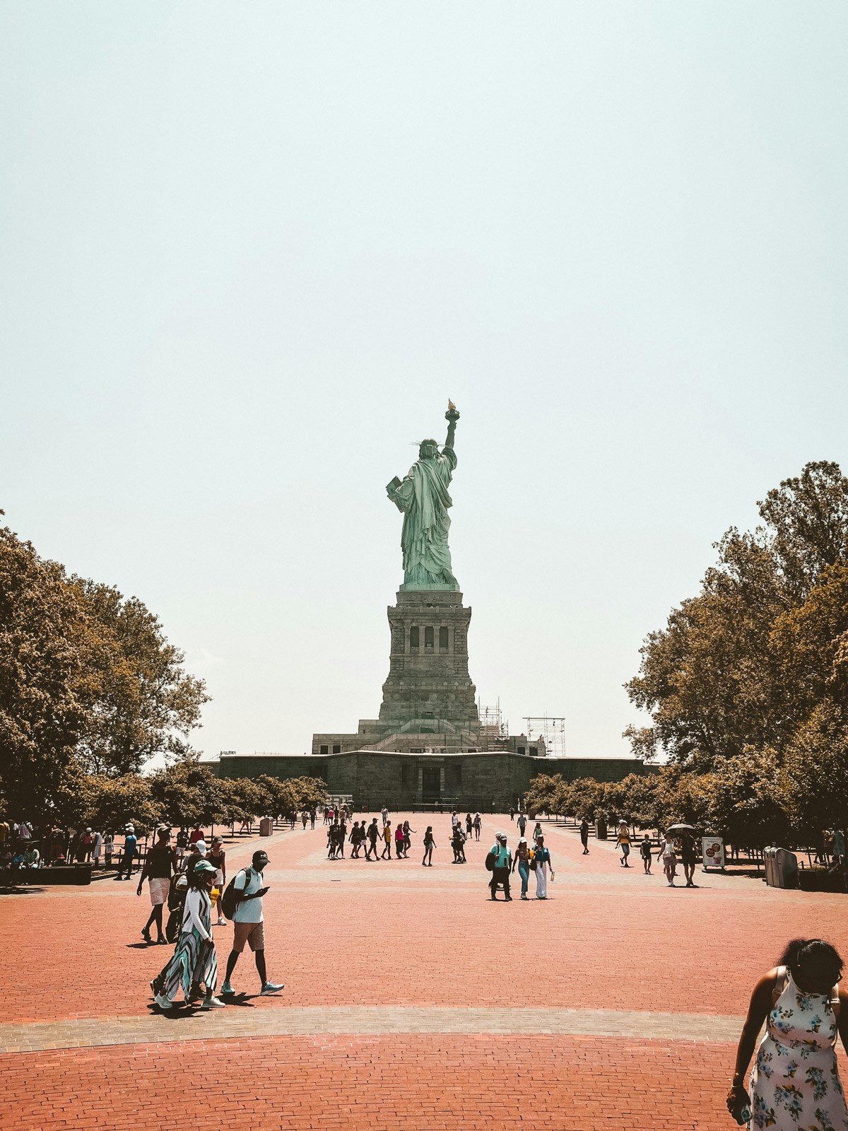 Visitors walking toward the Statue of Liberty on Liberty Island