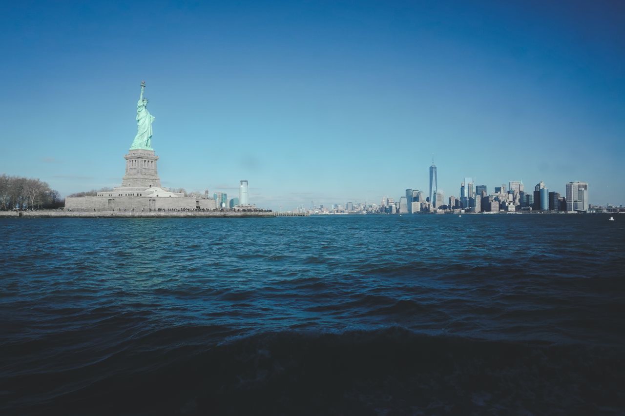 The Statue of Liberty and the Manhattan skyline across the harbor