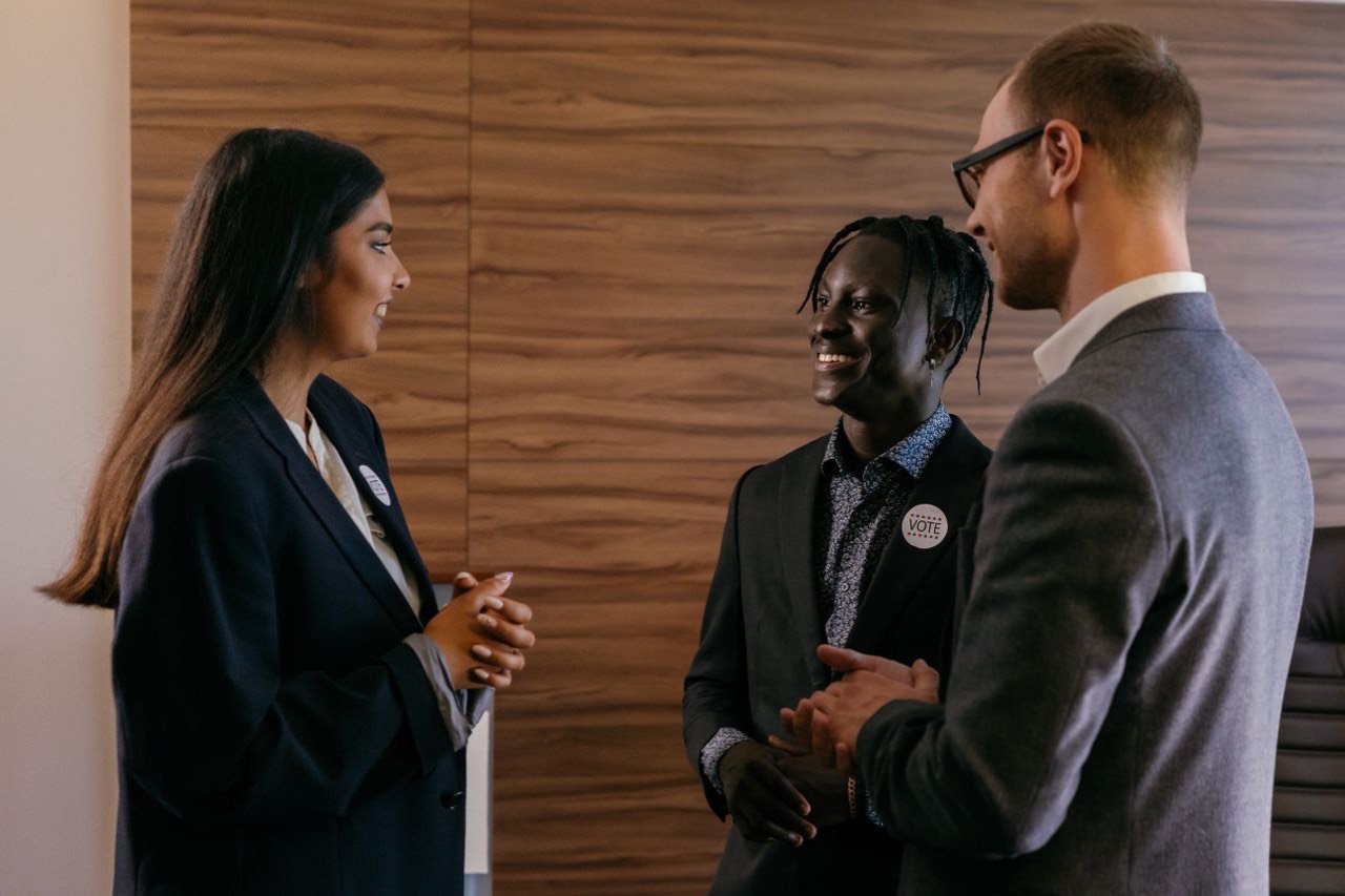 Young professionals in conversation at an evening reception