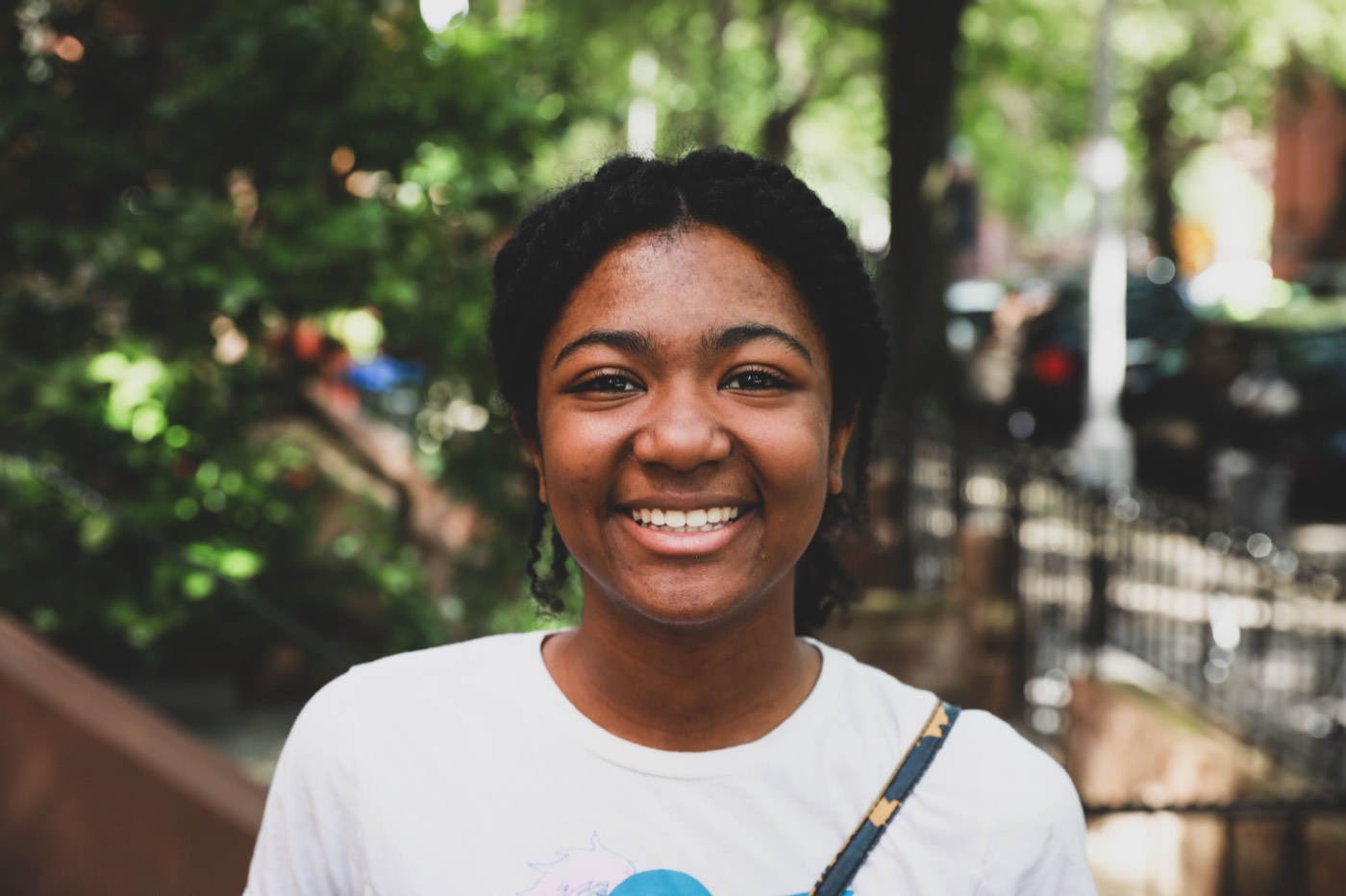 Portrait of a smiling young woman outdoors in a city park